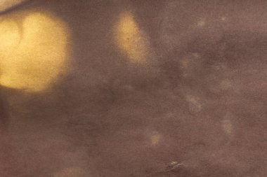 Aged paper sheet. Blank old background with dust and dirty stains. Vintage and antique art concept. Poster mockup. Detailed closeup studio shot. Front view. Toned