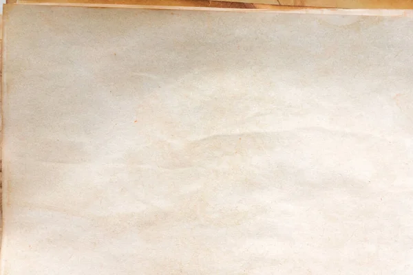 Aged paper sheet. Blank old background with dust and dirty stains. Vintage and antique art concept. Poster mockup. Detailed closeup studio shot. Front view. Toned