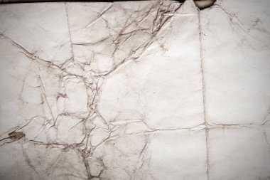 Eski kağıt çarşaf. Toz ve kirli lekelerle dolu boş bir arka plan. Eski ve antika sanat konsepti. Ayrıntılı yakın çekim stüdyo çekimi. Ön manzara. Ayarlanmış