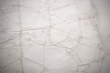 Eski kağıt çarşaf. Toz ve kirli lekelerle dolu boş bir arka plan. Eski ve antika sanat konsepti. Ayrıntılı yakın çekim stüdyo çekimi. Ön manzara. Ayarlanmış