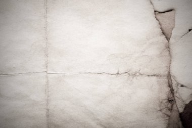 Eski kağıt çarşaf. Toz ve kirli lekelerle dolu boş bir arka plan. Eski ve antika sanat konsepti. Ayrıntılı yakın çekim stüdyo çekimi. Ön manzara. Ayarlanmış