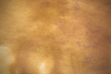 Aged paper sheet. Blank old background with dust and dirty stains. Vintage and antique art concept. Poster mockup. Detailed closeup studio shot. Front view. Toned