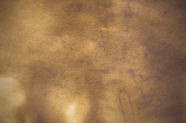 Aged paper sheet. Blank old background with dust and dirty stains. Vintage and antique art concept. Poster mockup. Detailed closeup studio shot. Front view. Toned