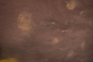 Aged paper sheet. Blank old background with dust and dirty stains. Vintage and antique art concept. Poster mockup. Detailed closeup studio shot. Front view. Toned