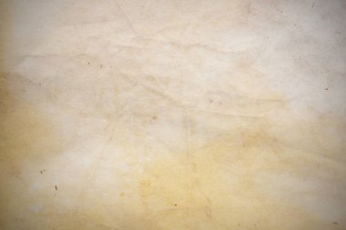 Aged paper sheet. Blank old background with dust and dirty stains. Vintage and antique art concept. Poster mockup. Detailed closeup studio shot. Front view. Toned