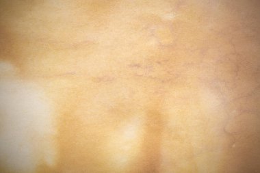 Aged paper sheet. Blank old background with dust and dirty stains. Vintage and antique art concept. Poster mockup. Detailed closeup studio shot. Front view. Toned