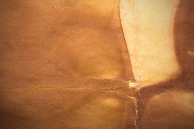 Aged paper sheet. Blank old background with dust and dirty stains. Vintage and antique art concept. Poster mockup. Detailed closeup studio shot. Front view. Toned