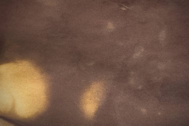 Aged paper sheet. Blank old background with dust and dirty stains. Vintage and antique art concept. Poster mockup. Detailed closeup studio shot. Front view. Toned