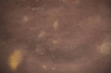 Aged paper sheet. Blank old background with dust and dirty stains. Vintage and antique art concept. Poster mockup. Detailed closeup studio shot. Front view. Toned