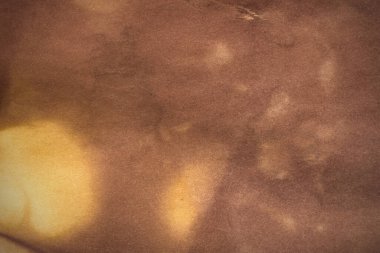 Aged paper sheet. Blank old background with dust and dirty stains. Vintage and antique art concept. Poster mockup. Detailed closeup studio shot. Front view. Toned