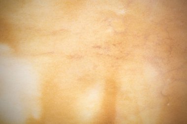 Aged paper sheet. Blank old background with dust and dirty stains. Vintage and antique art concept. Poster mockup. Detailed closeup studio shot. Front view. Toned