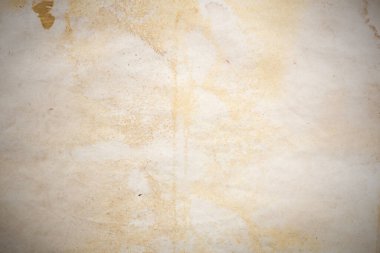 Aged paper sheet. Blank old background with dust and dirty stains. Vintage and antique art concept. Poster mockup. Detailed closeup studio shot. Front view. Toned