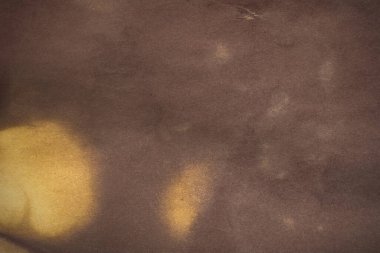 Aged paper sheet. Blank old background with dust and dirty stains. Vintage and antique art concept. Poster mockup. Detailed closeup studio shot. Front view. Toned