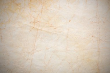 Aged paper sheet. Blank old background with dust and dirty stains. Vintage and antique art concept. Poster mockup. Detailed closeup studio shot. Front view. Toned