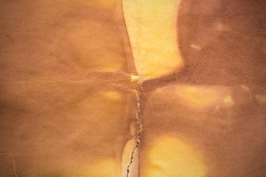 Aged paper sheet. Blank old background with dust and dirty stains. Vintage and antique art concept. Poster mockup. Detailed closeup studio shot. Front view. Toned