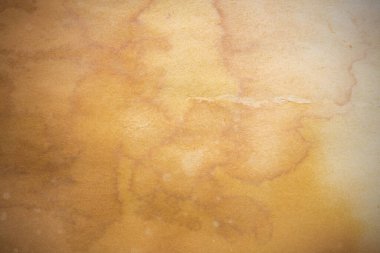 Aged paper sheet. Blank old background with dust and dirty stains. Vintage and antique art concept. Poster mockup. Detailed closeup studio shot. Front view. Toned