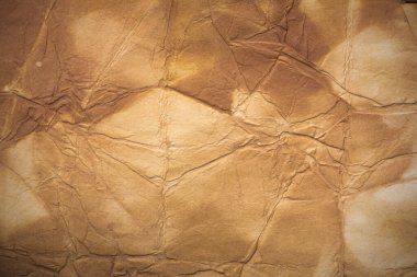 Aged paper sheet. Blank old background with dust and dirty stains. Vintage and antique art concept. Poster mockup. Detailed closeup studio shot. Front view. Toned