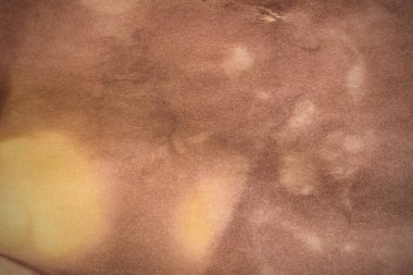 Aged paper sheet. Blank old background with dust and dirty stains. Vintage and antique art concept. Poster mockup. Detailed closeup studio shot. Front view. Toned