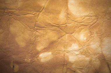 Aged paper sheet. Blank old background with dust and dirty stains. Vintage and antique art concept. Poster mockup. Detailed closeup studio shot. Front view. Toned