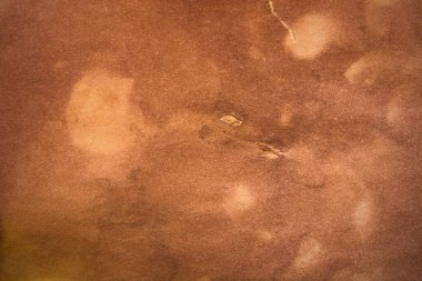 Aged paper sheet. Blank old background with dust and dirty stains. Vintage and antique art concept. Poster mockup. Detailed closeup studio shot. Front view. Toned