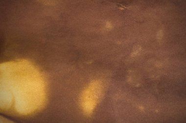 Aged paper sheet. Blank old background with dust and dirty stains. Vintage and antique art concept. Poster mockup. Detailed closeup studio shot. Front view. Toned