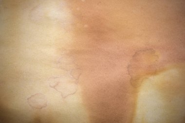 Aged paper sheet. Blank old background with dust and dirty stains. Vintage and antique art concept. Poster mockup. Detailed closeup studio shot. Front view. Toned