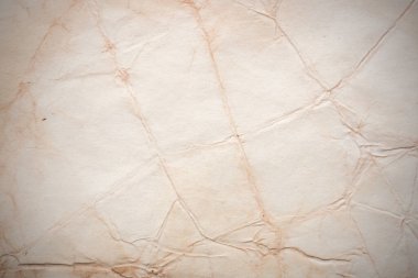 Aged paper sheet. Blank old background with dust and dirty stains. Vintage and antique art concept. Poster mockup. Detailed closeup studio shot. Front view. Toned