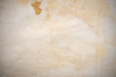 Aged paper sheet. Blank old background with dust and dirty stains. Vintage and antique art concept. Poster mockup. Detailed closeup studio shot. Front view. Toned