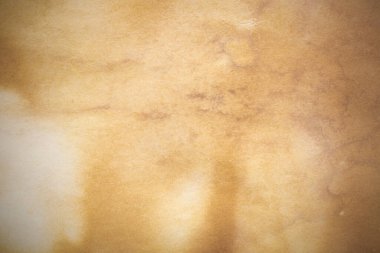 Aged paper sheet. Blank old background with dust and dirty stains. Vintage and antique art concept. Poster mockup. Detailed closeup studio shot. Front view. Toned