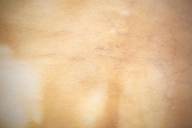 Aged paper sheet. Blank old background with dust and dirty stains. Vintage and antique art concept. Poster mockup. Detailed closeup studio shot. Front view. Toned