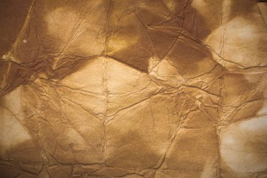 Aged paper sheet. Blank old background with dust and dirty stains. Vintage and antique art concept. Poster mockup. Detailed closeup studio shot. Front view. Toned