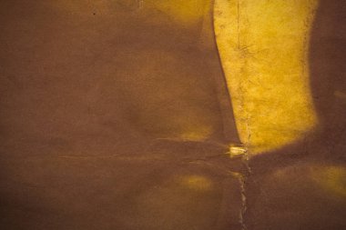 Aged paper sheet. Blank old background with dust and dirty stains. Vintage and antique art concept. Poster mockup. Detailed closeup studio shot. Front view. Toned