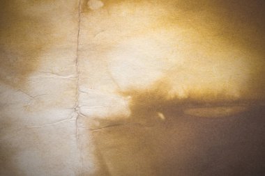 Aged paper sheet. Blank old background with dust and dirty stains. Vintage and antique art concept. Poster mockup. Detailed closeup studio shot. Front view. Toned