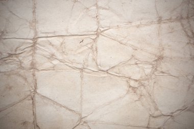 Aged paper sheet. Blank old background with dust and dirty stains. Vintage and antique art concept. Poster mockup. Detailed closeup studio shot. Front view. Toned