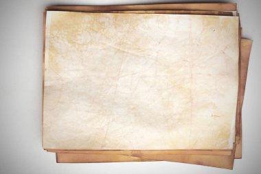 Aged paper sheet. Blank old background with dust and dirty stains. Vintage and antique art concept. Poster mockup. Detailed closeup studio shot. Front view. Toned