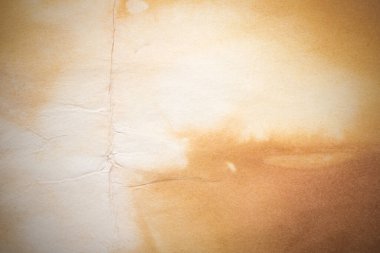 Aged paper sheet. Blank old background with dust and dirty stains. Vintage and antique art concept. Poster mockup. Detailed closeup studio shot. Front view. Toned