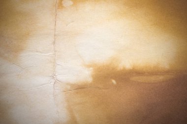 Aged paper sheet. Blank old background with dust and dirty stains. Vintage and antique art concept. Poster mockup. Detailed closeup studio shot. Front view. Toned