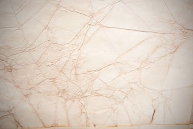 Aged paper sheet. Blank old background with dust and dirty stains. Vintage and antique art concept. Poster mockup. Detailed closeup studio shot. Front view. Toned