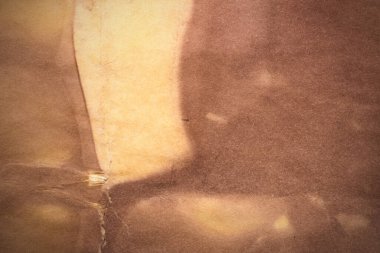 Aged paper sheet. Blank old background with dust and dirty stains. Vintage and antique art concept. Poster mockup. Detailed closeup studio shot. Front view. Toned