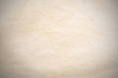 Aged paper sheet. Blank old background with dust and dirty stains. Vintage and antique art concept. Poster mockup. Detailed closeup studio shot. Front view. Toned