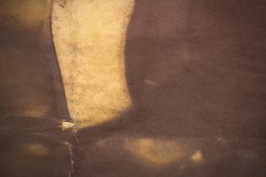 Aged paper sheet. Blank old background with dust and dirty stains. Vintage and antique art concept. Poster mockup. Detailed closeup studio shot. Front view. Toned