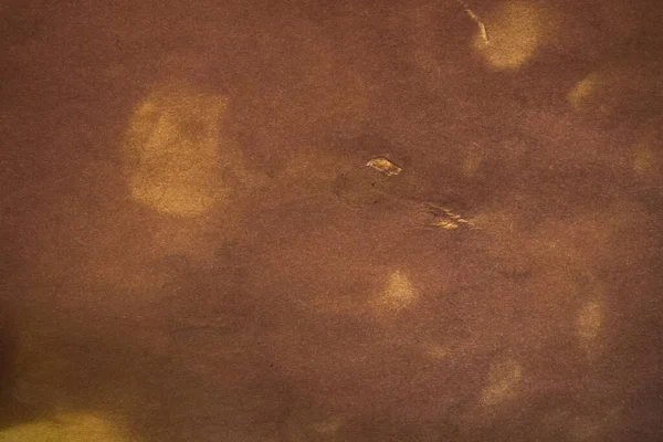 Aged paper sheet. Blank old background with dust and dirty stains. Vintage and antique art concept. Poster mockup. Detailed closeup studio shot. Front view. Toned