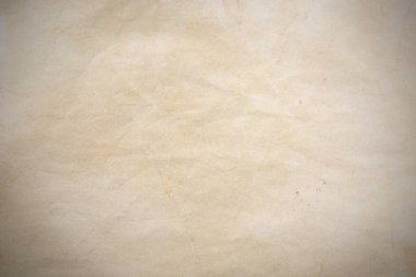 Aged paper sheet. Blank old background with dust and dirty stains. Vintage and antique art concept. Poster mockup. Detailed closeup studio shot. Front view. Toned