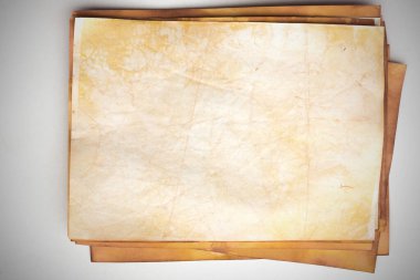 Aged paper sheet. Blank old background with dust and dirty stains. Vintage and antique art concept. Poster mockup. Detailed closeup studio shot. Front view. Toned