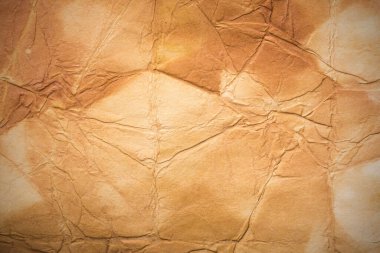 Aged paper sheet. Blank old background with dust and dirty stains. Vintage and antique art concept. Poster mockup. Detailed closeup studio shot. Front view. Toned