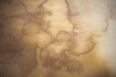 Aged paper sheet. Blank old background with dust and dirty stains. Vintage and antique art concept. Poster mockup. Detailed closeup studio shot. Front view. Toned