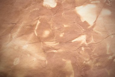 Aged paper sheet. Blank old background with dust and dirty stains. Vintage and antique art concept. Poster mockup. Detailed closeup studio shot. Front view. Toned