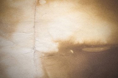 Aged paper sheet. Blank old background with dust and dirty stains. Vintage and antique art concept. Poster mockup. Detailed closeup studio shot. Front view. Toned