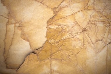 Aged paper sheet. Blank old background with dust and dirty stains. Vintage and antique art concept. Poster mockup. Detailed closeup studio shot. Front view. Toned