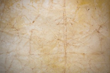 Aged paper sheet. Blank old background with dust and dirty stains. Vintage and antique art concept. Poster mockup. Detailed closeup studio shot. Front view. Toned